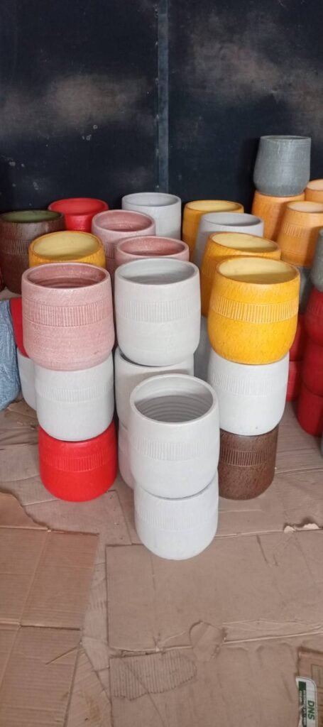 Stacks of banded tumbler pots in several colours