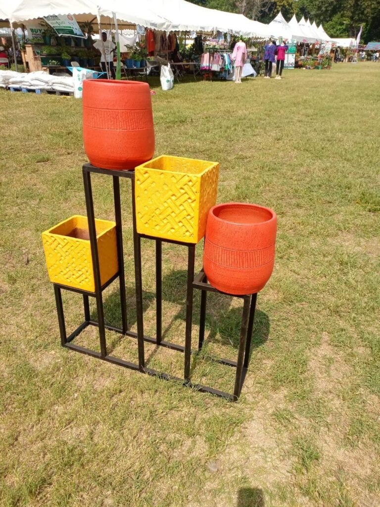 Yellow basket-weave square pots and orange banded round pots on a stepped stand