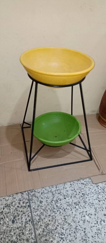 Yellow and green shallow bowl planters on a black metal stand