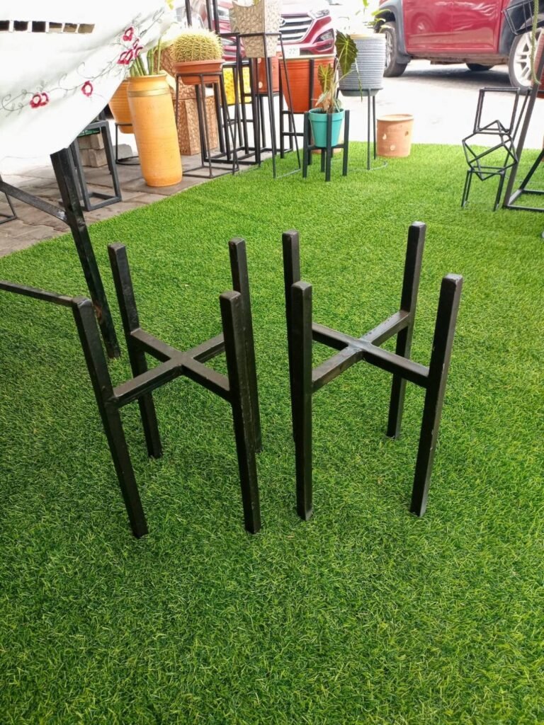Two black cross-base metal pot stands