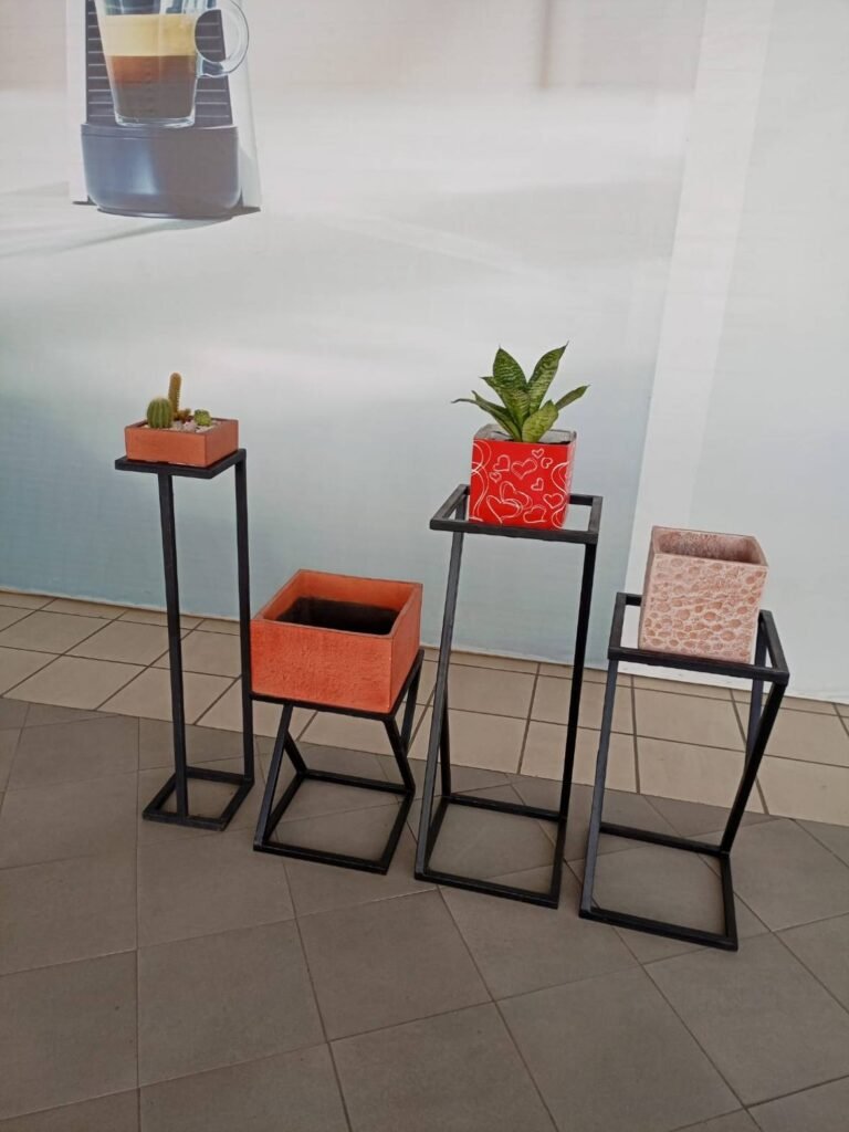Geometric pedestal plant stands in four heights holding square pots