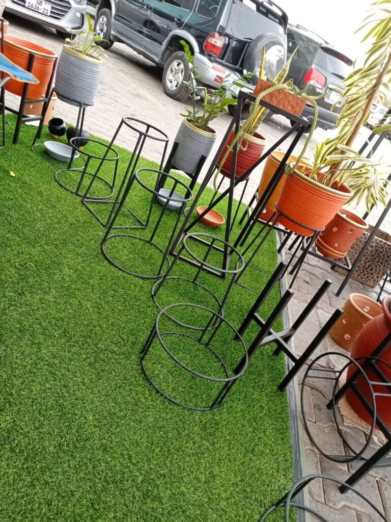 Round ring metal pot stands displayed with potted plants