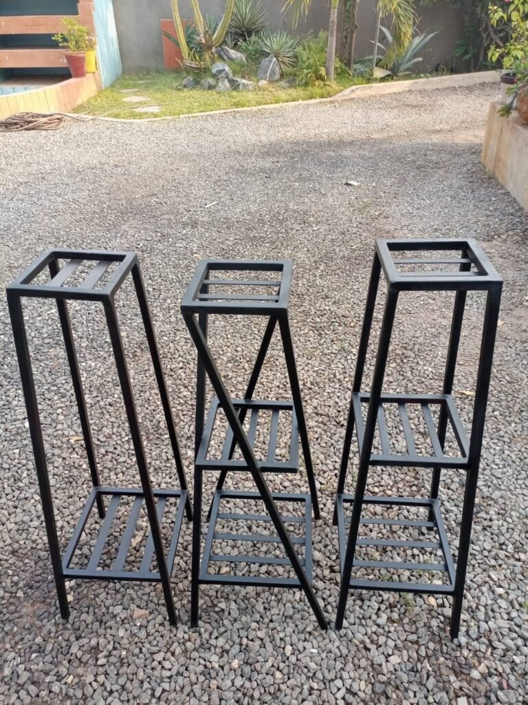 Three tall tiered black metal plant stands