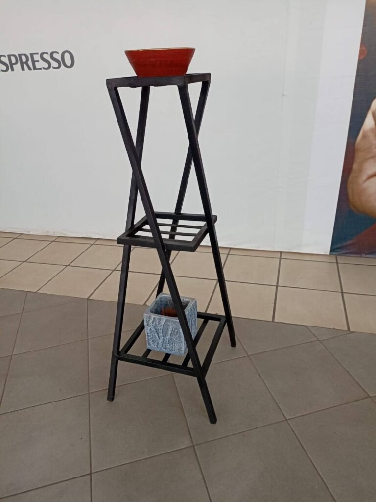 Tall X-frame metal plant stand with three shelves